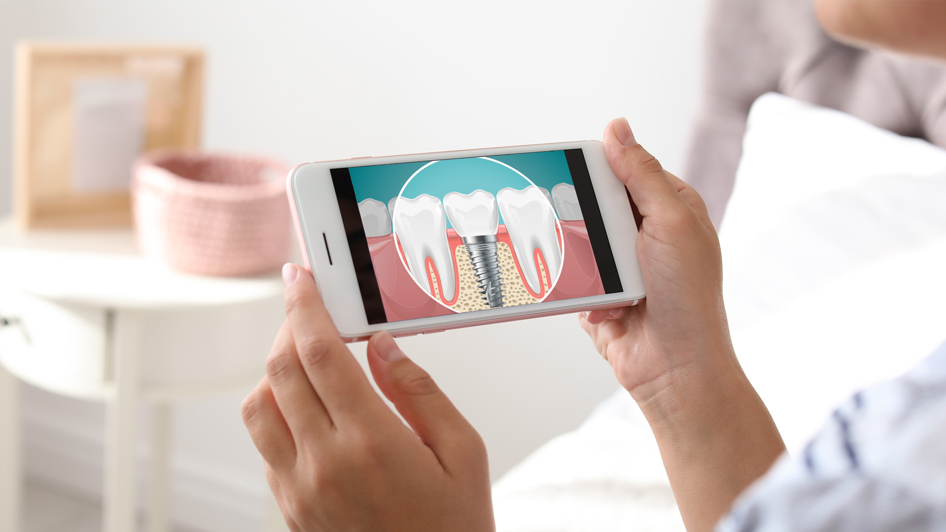 The image shows a person holding a smartphone displaying a graphic of a tooth with gum disease, suggesting dental health awareness or education.